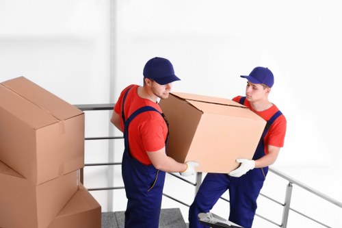 Movers loading household items carefully for a Kingston Vale relocation