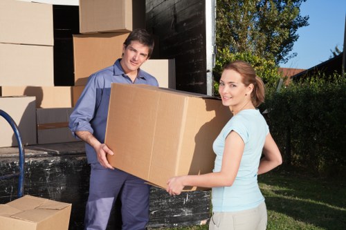 Professional movers carrying furniture through a residential property